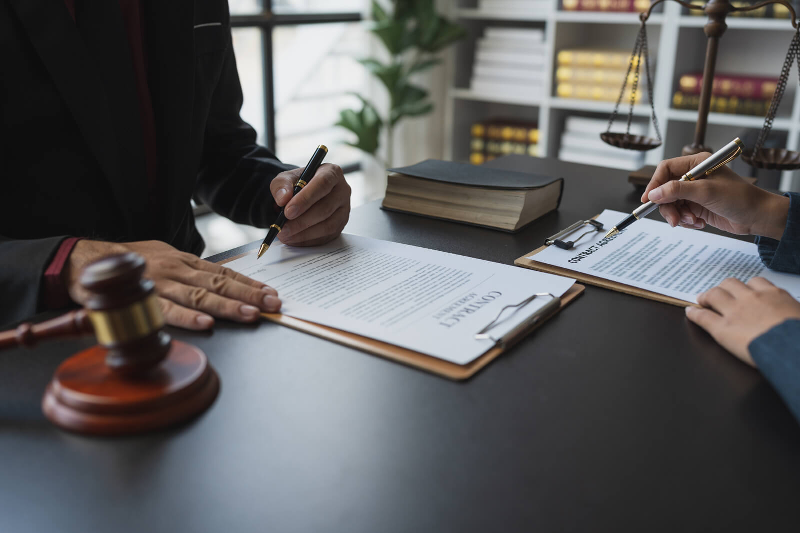 people signing legal documents